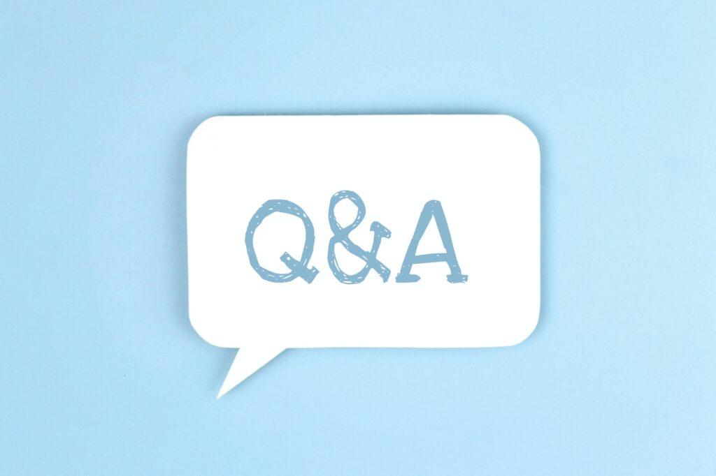 White paper speech bubble with inscription Q&A. Questions and answers