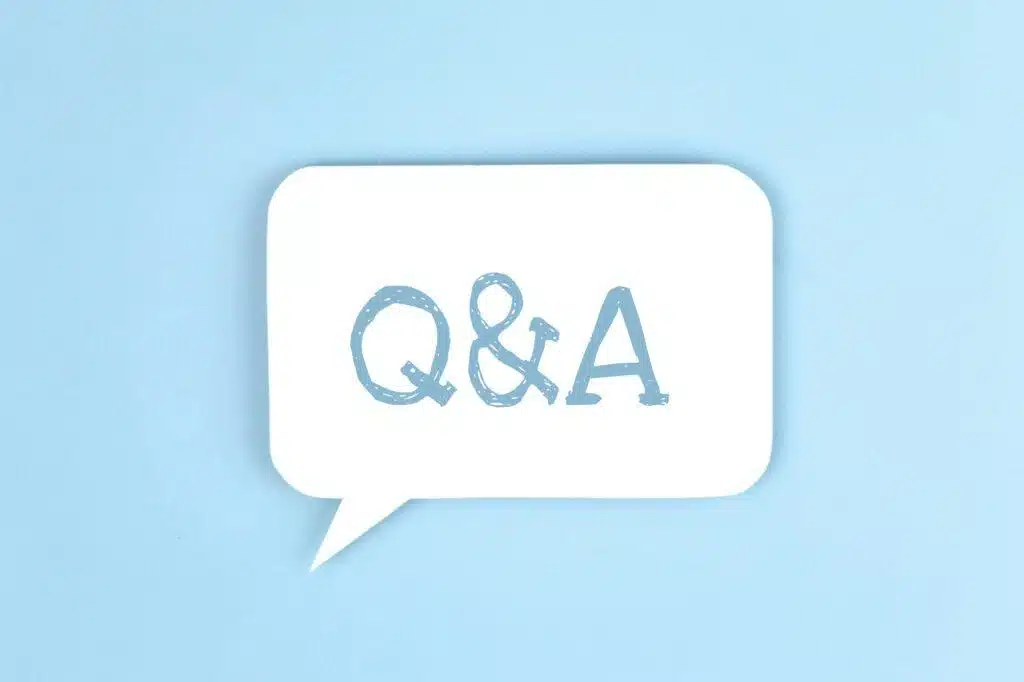 White paper speech bubble with inscription Q&A. Questions and answers